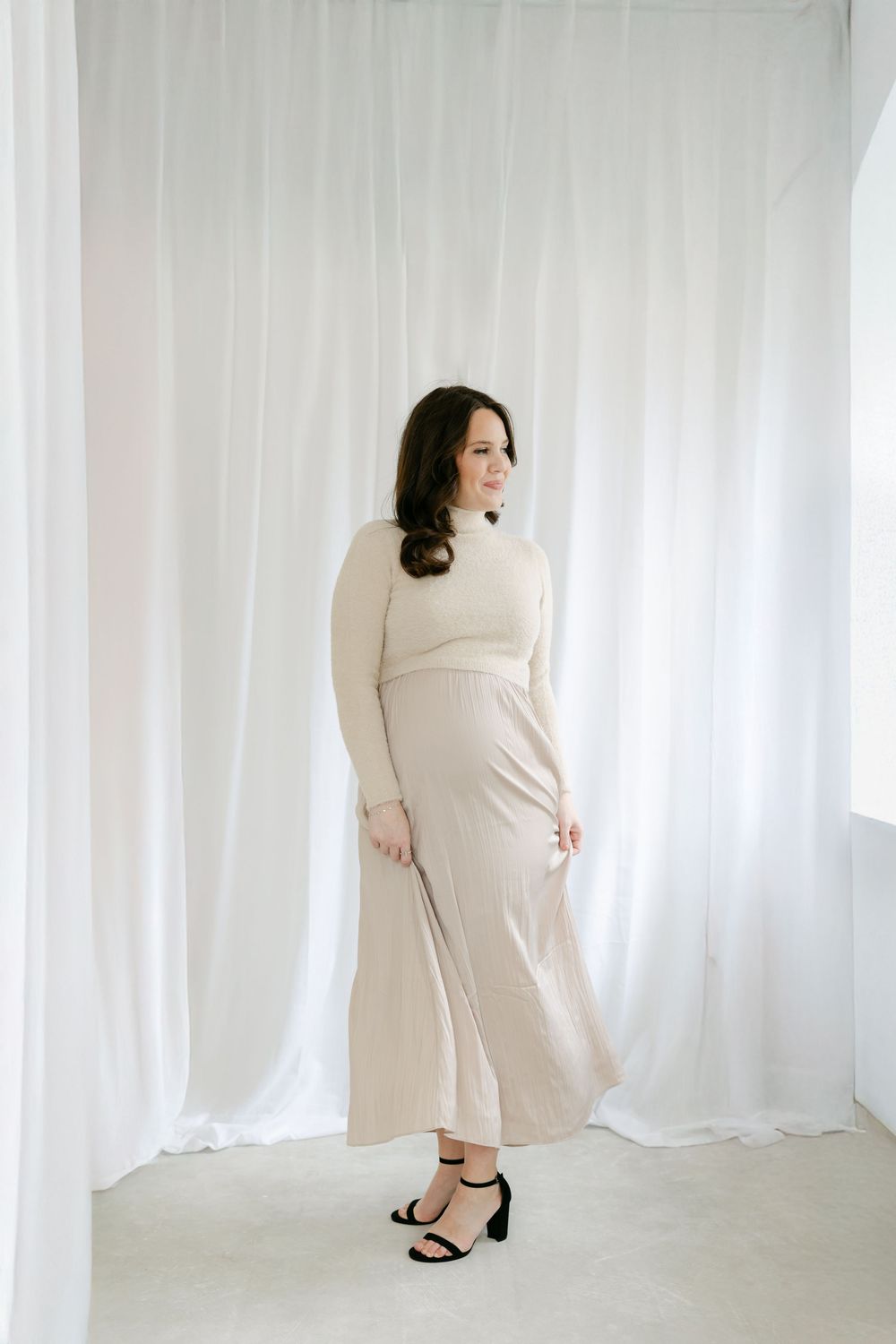 A series of four minimalist photographs showing a figure in white against a bright white backdrop with curtains. Hartford Photography