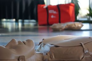 Multiple beige mannequins lying on display tables in a retail setting.
