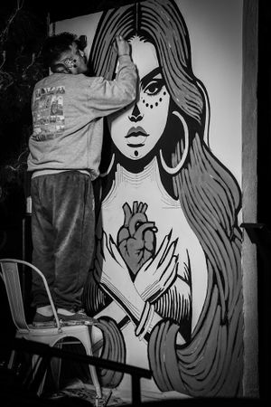 Black and white artistic mural series featuring stylized female illustrations with flowing hair.