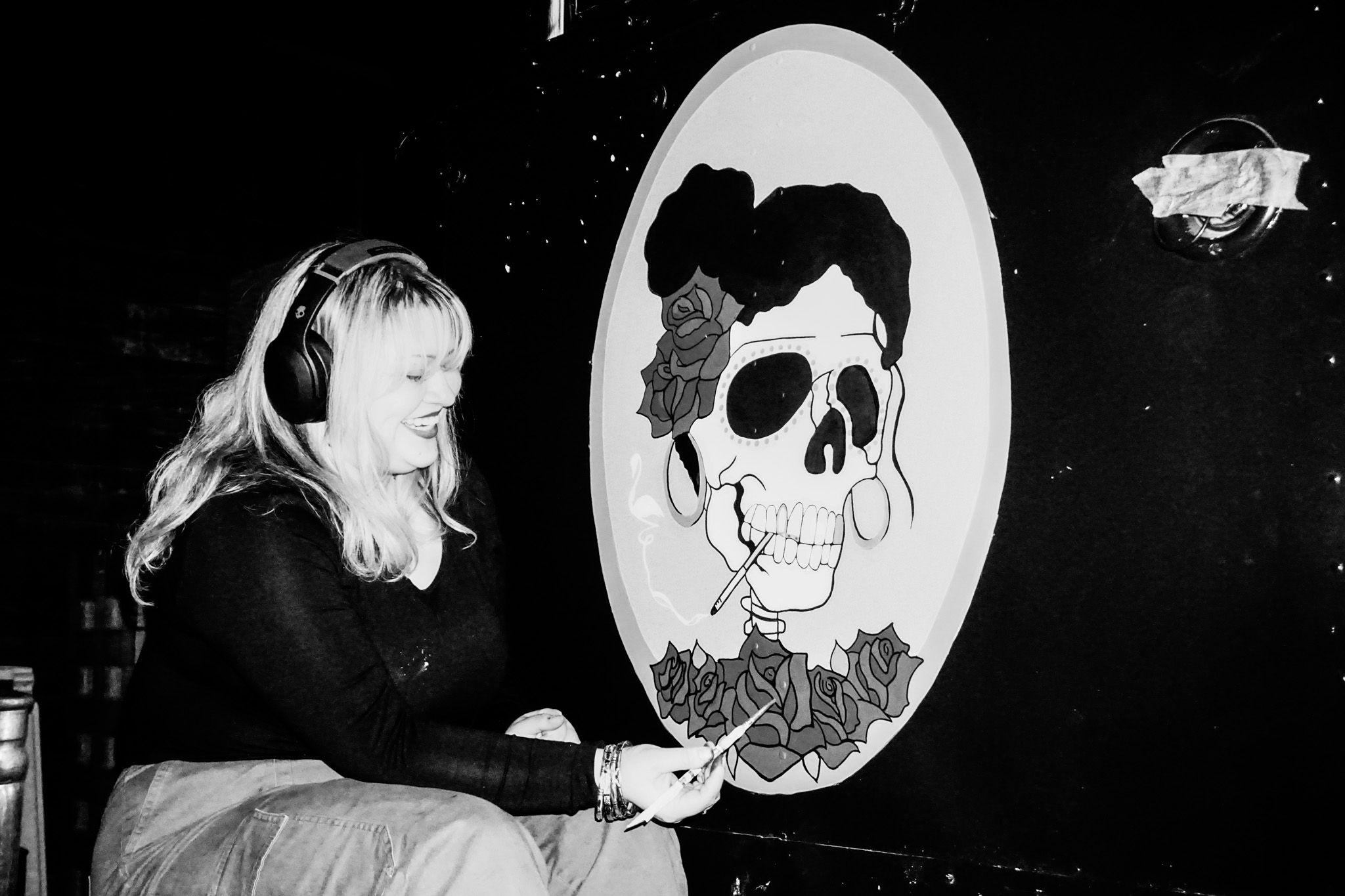 Black and white artistic photographs displayed in a dark gallery setting.