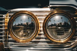 Series of vintage gold-framed mirrors reflecting architectural details.