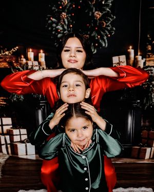 Holiday photo session with people in matching pajamas posing playfully.