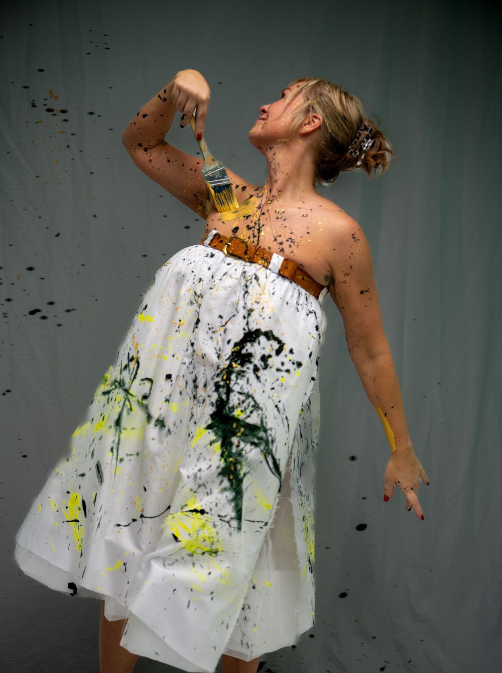 Artistic photo series showing paint splatter effects on white fabric against a dark background.