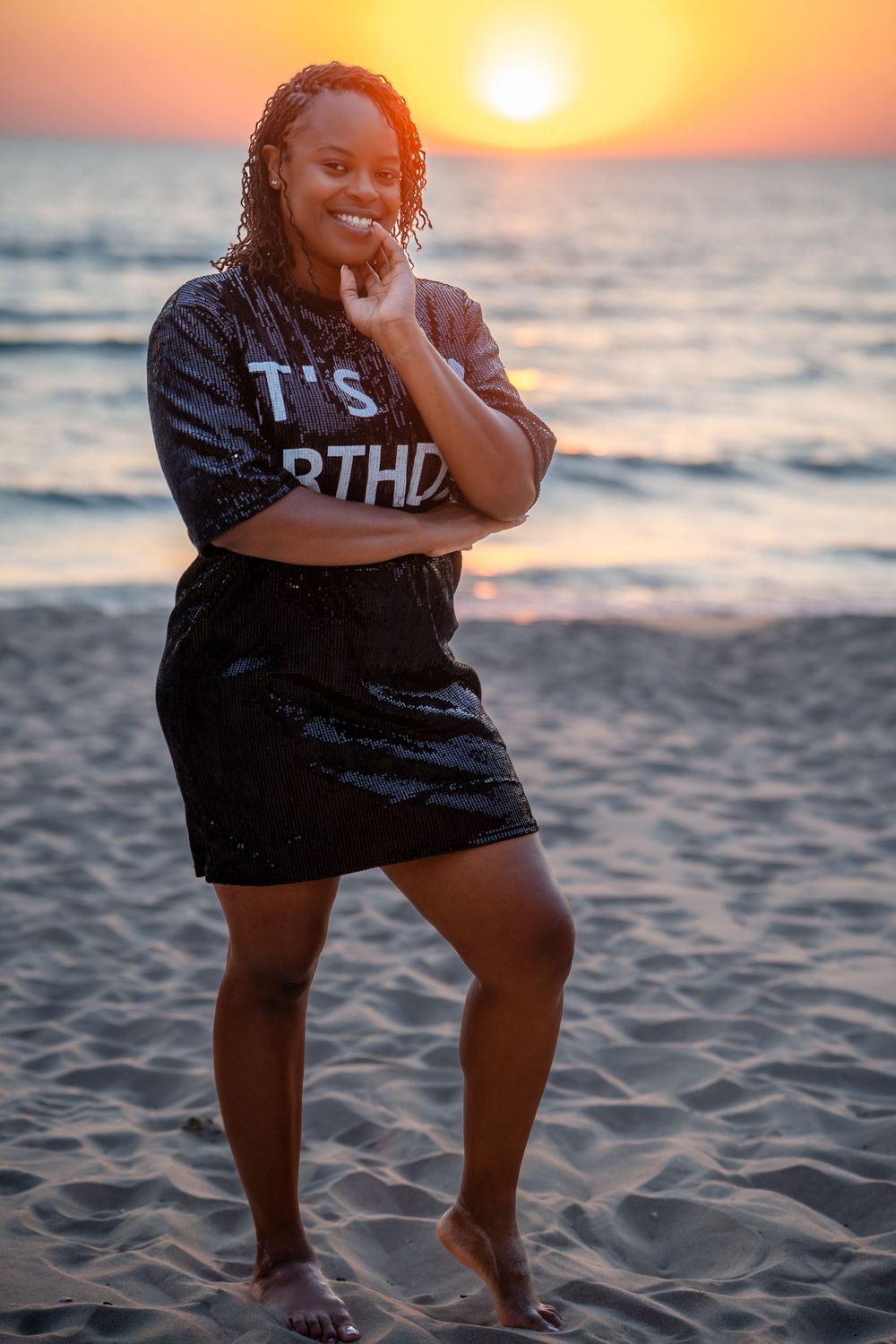 Beach sunset photoshoot with playful poses against golden sky and ocean backdrop.