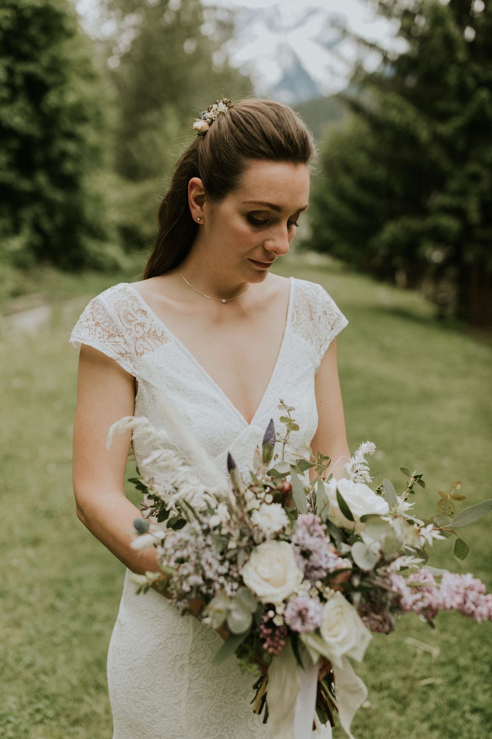 Close-up shots of a bridal bouquet featuring white roses and delicate purple flowers against a green background.