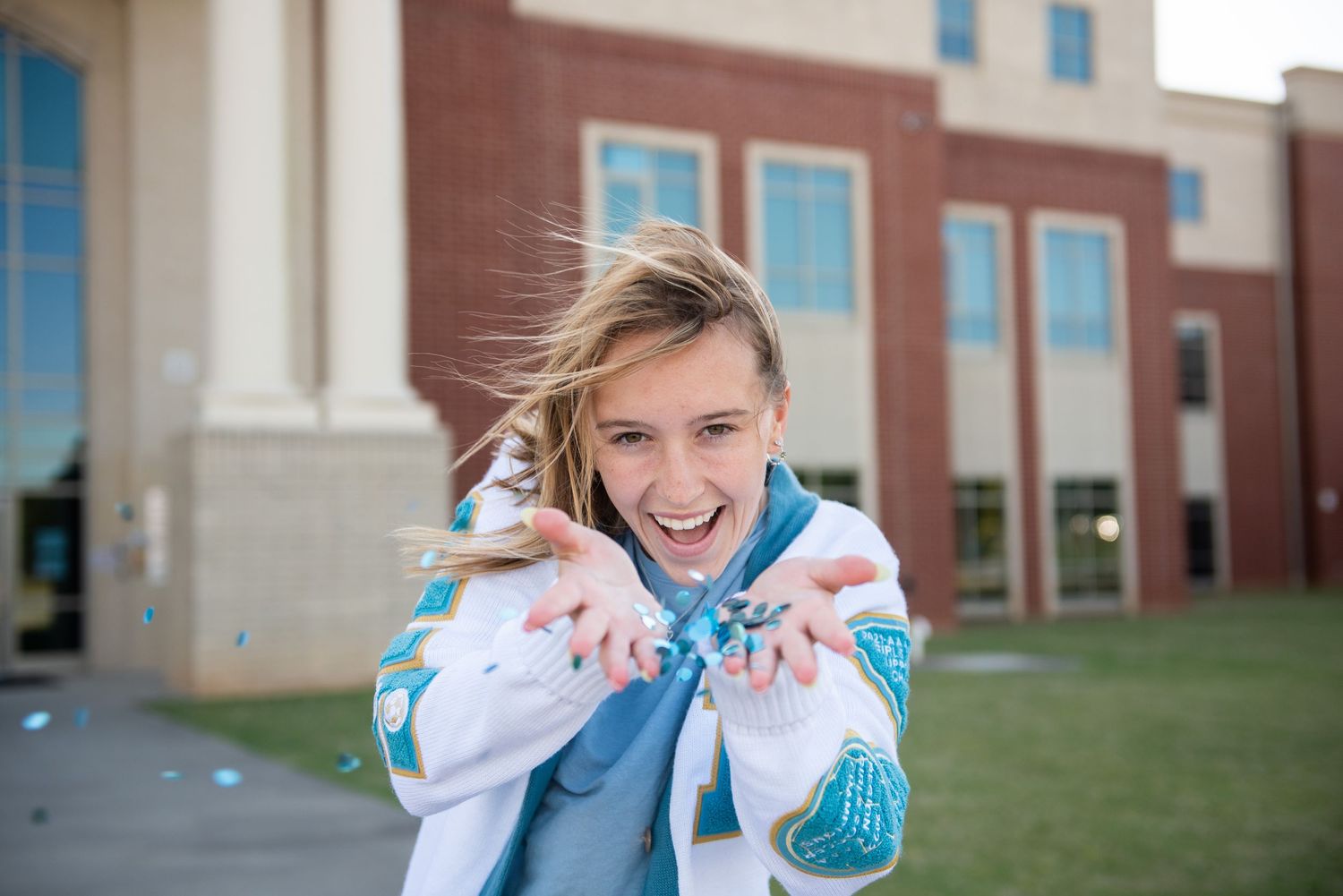 A sequence of four photos showing someone wearing a blue and white dress laughing and covering their mouth.