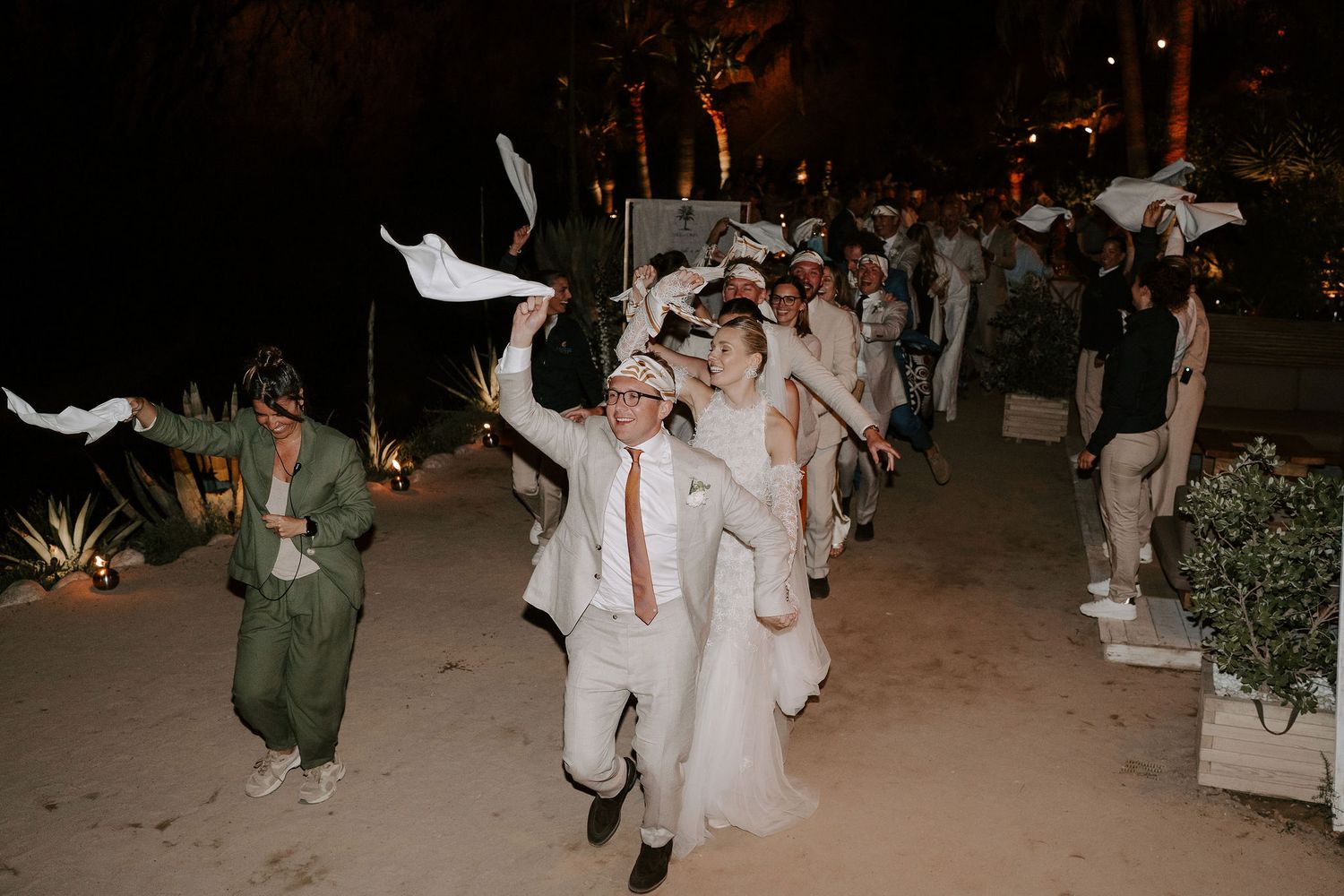 wedding party in a Congo line waving napkins at amante ibiza
