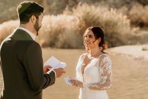 A couple sharing intimate moments while reading letters in warm desert lighting.