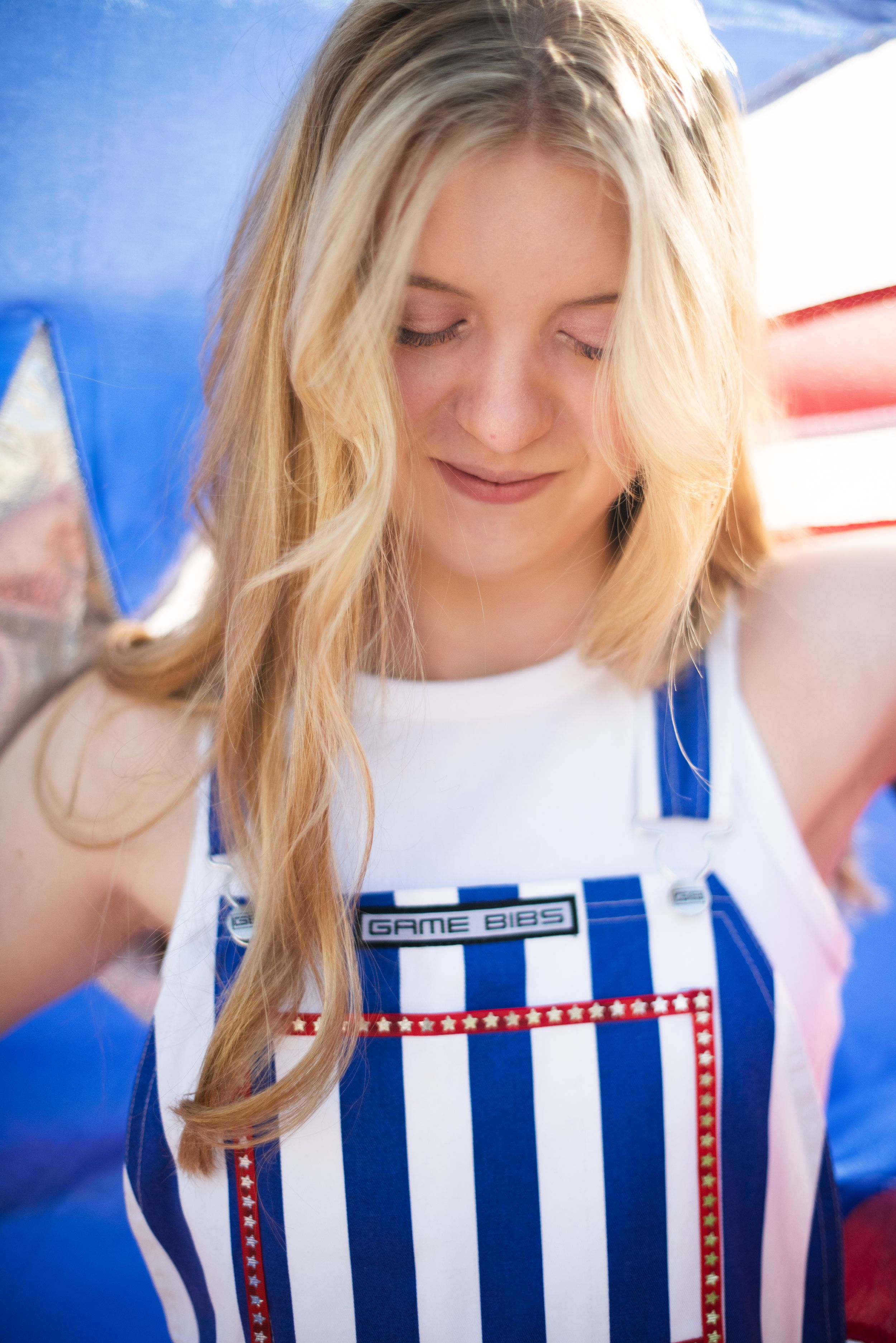 A series of photos showing a blue and white striped garment with red trim details against a bright background.
