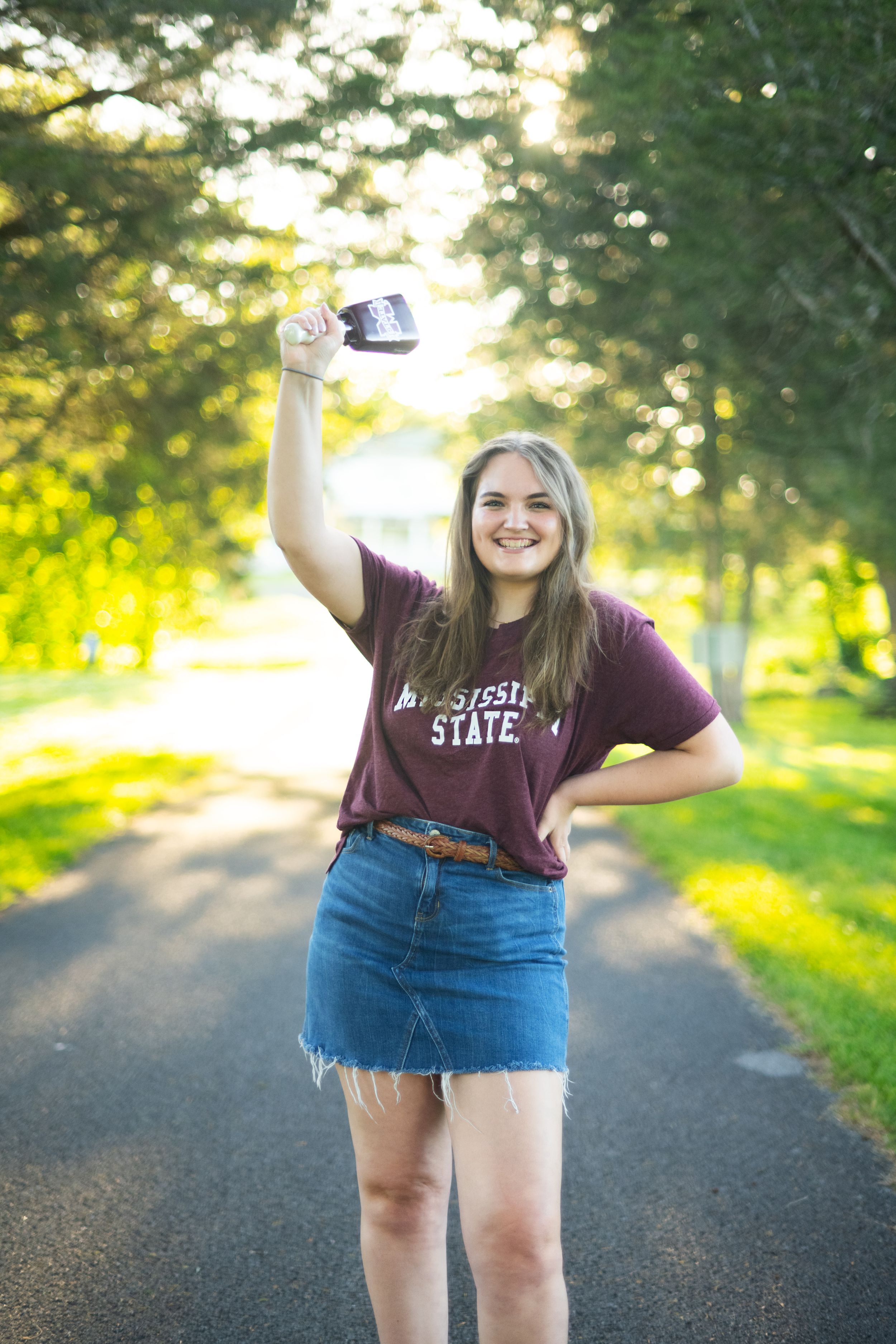 A series of photos showing a person in a maroon t-shirt and denim skirt standing on a sunlit wooded path.