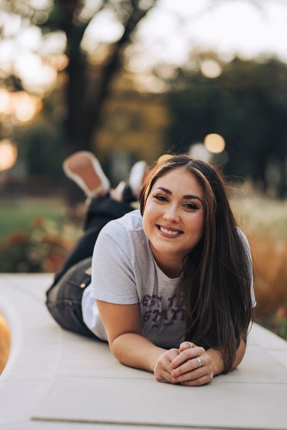 A relaxed outdoor photo session with natural lighting and bokeh effects.