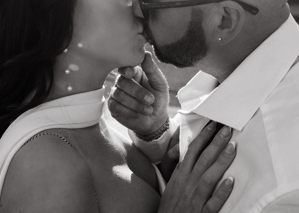 A series of black and white romantic photos showing a couple embracing and kissing.