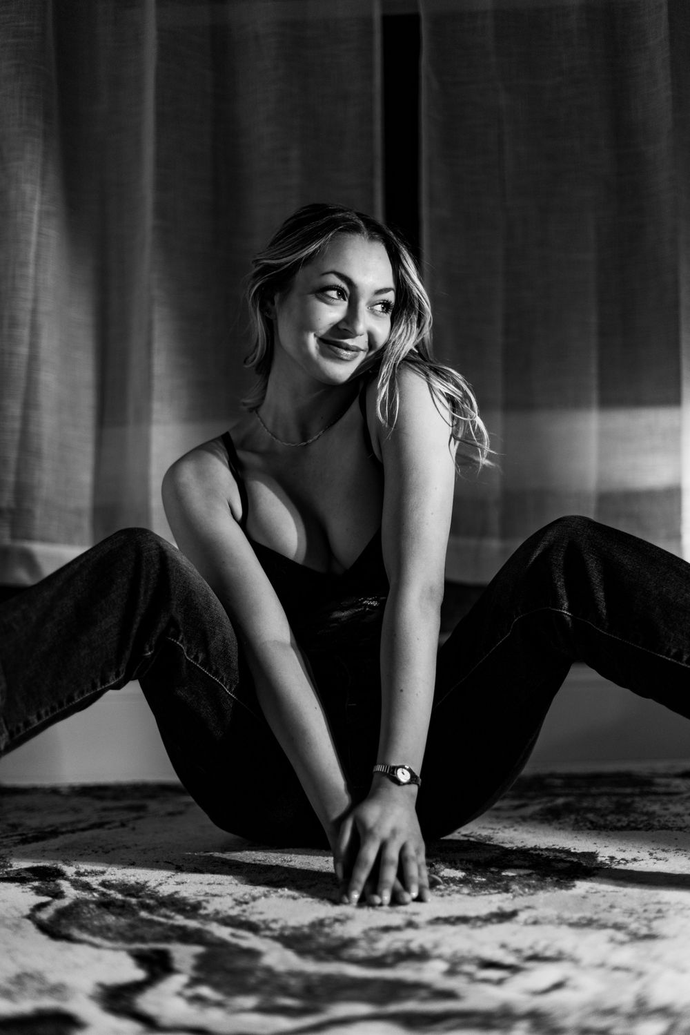 Black and white artistic photos of someone laying on a patterned floor in various poses.