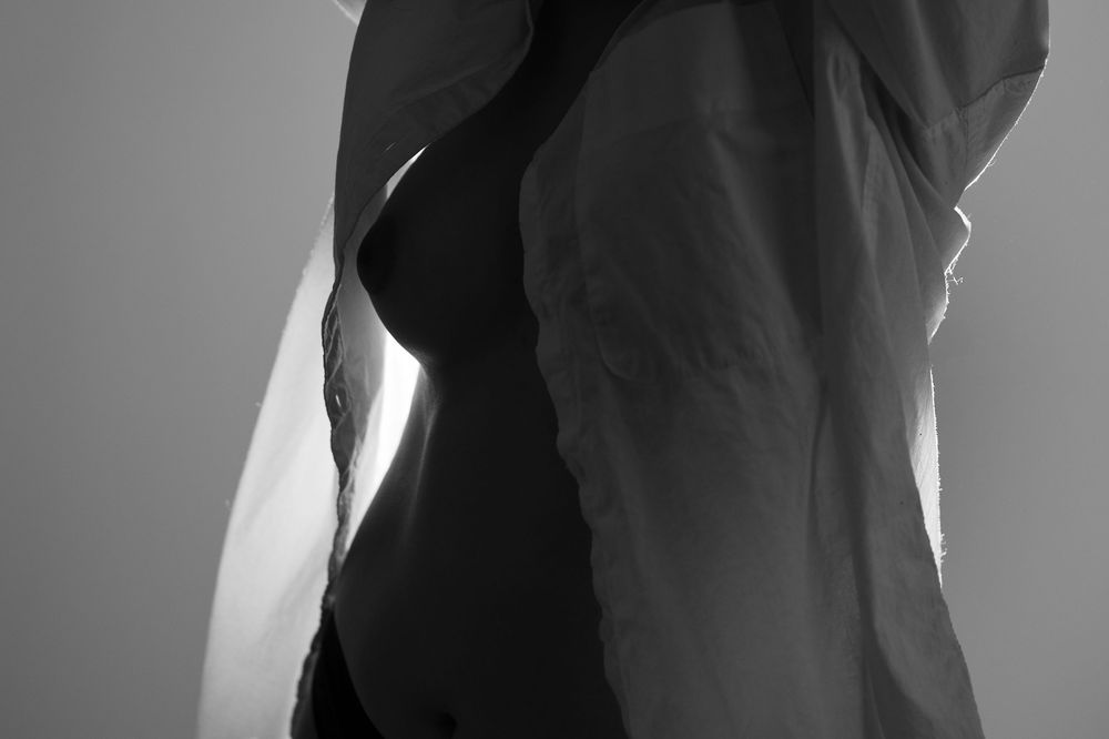 Black and white portrait photo series showing different facial expressions and poses against a light background.
