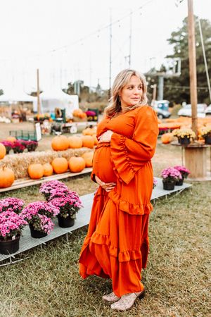 A series of fall images showing orange dresses against a backdrop of pumpkins and purple mums at a pumpkin patch.