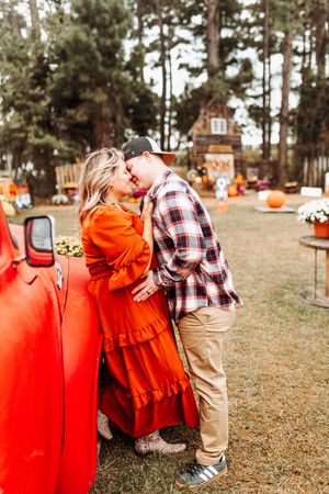 Three sequential photos showing a couple in a fall pumpkin patch setting with plaid and orange outfits.