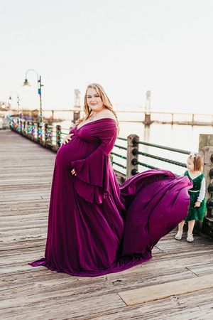 A series of photos showing someone in a flowing purple gown posing gracefully on a wooden pier at sunset.