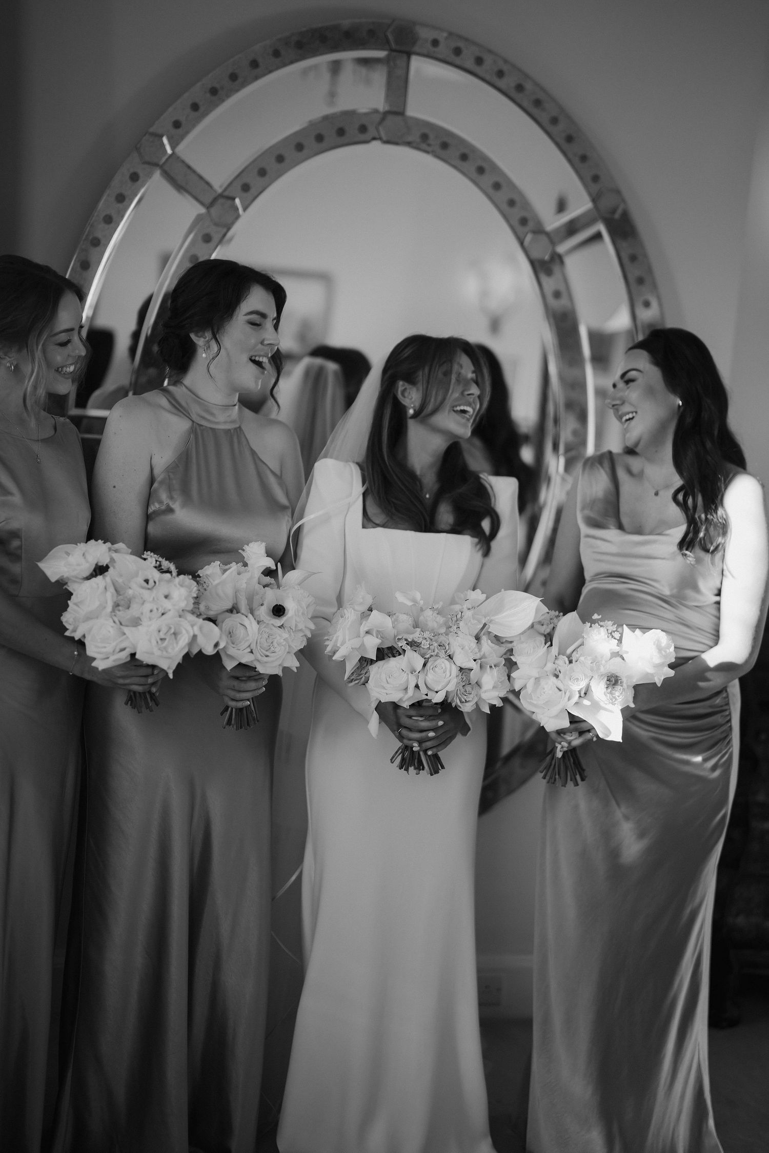 bride and bridesmaids looking at each other laughing before the ceremony at Iscoyd park