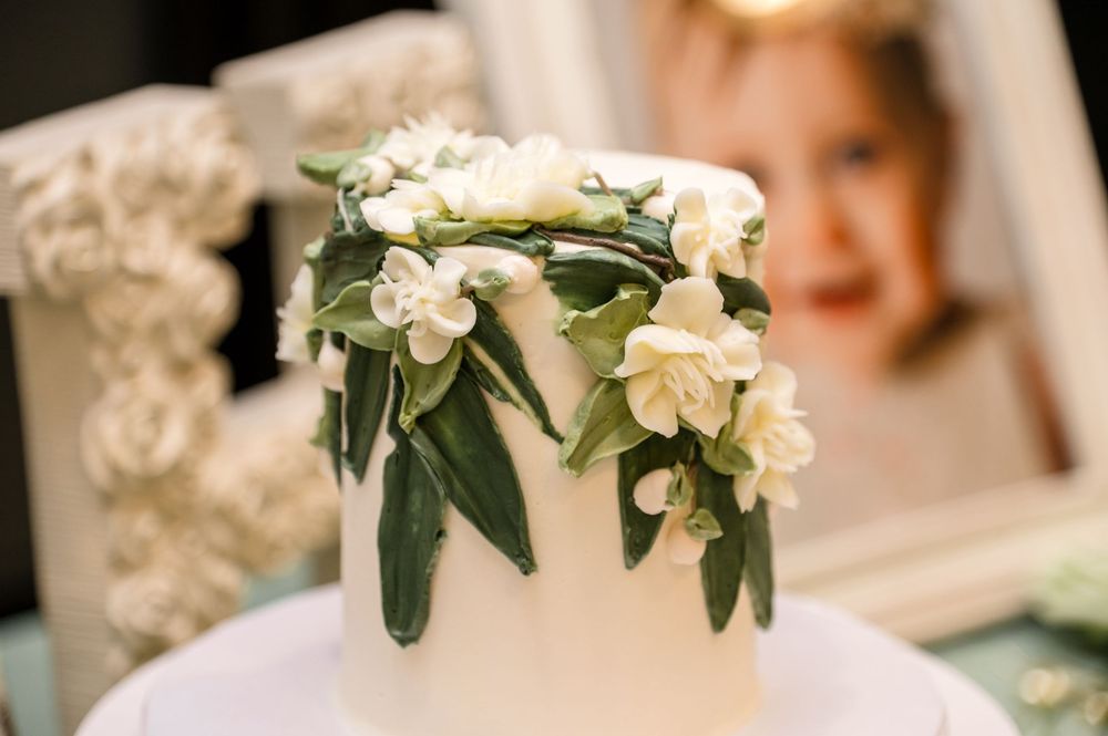 White floral bouquets and greenery arrangements decorate an elegant wedding venue setting.