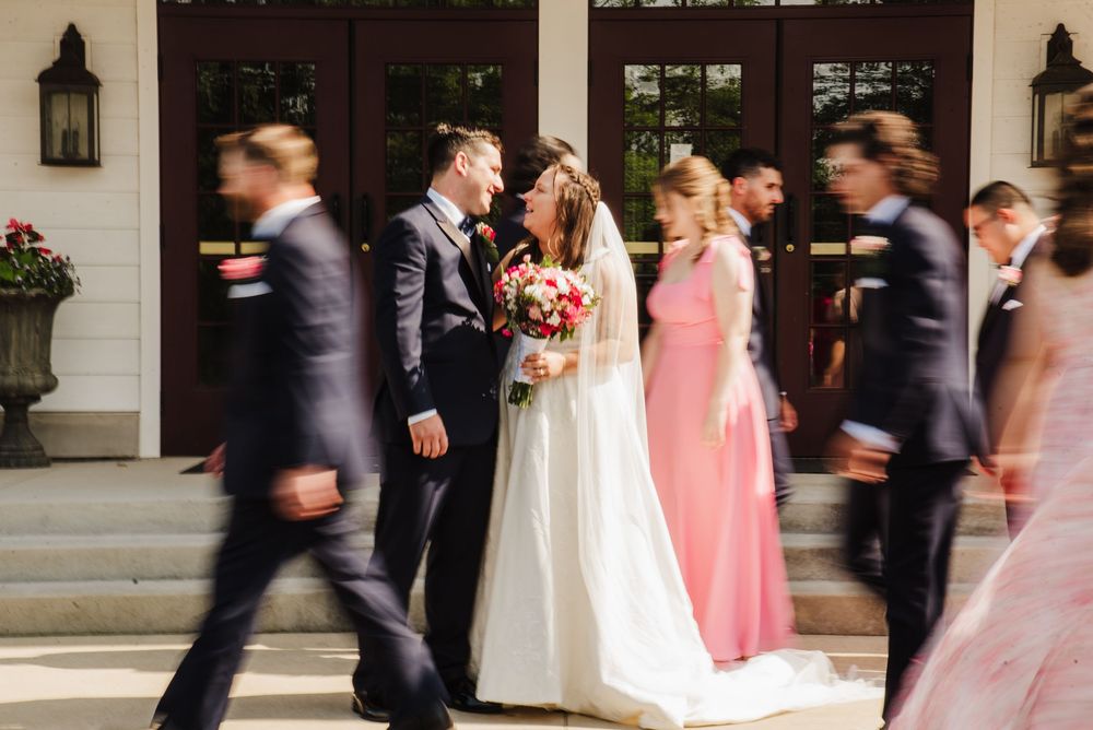 Wedding party in formal attire walks past white columns in a motion-blurred sequence of photos.