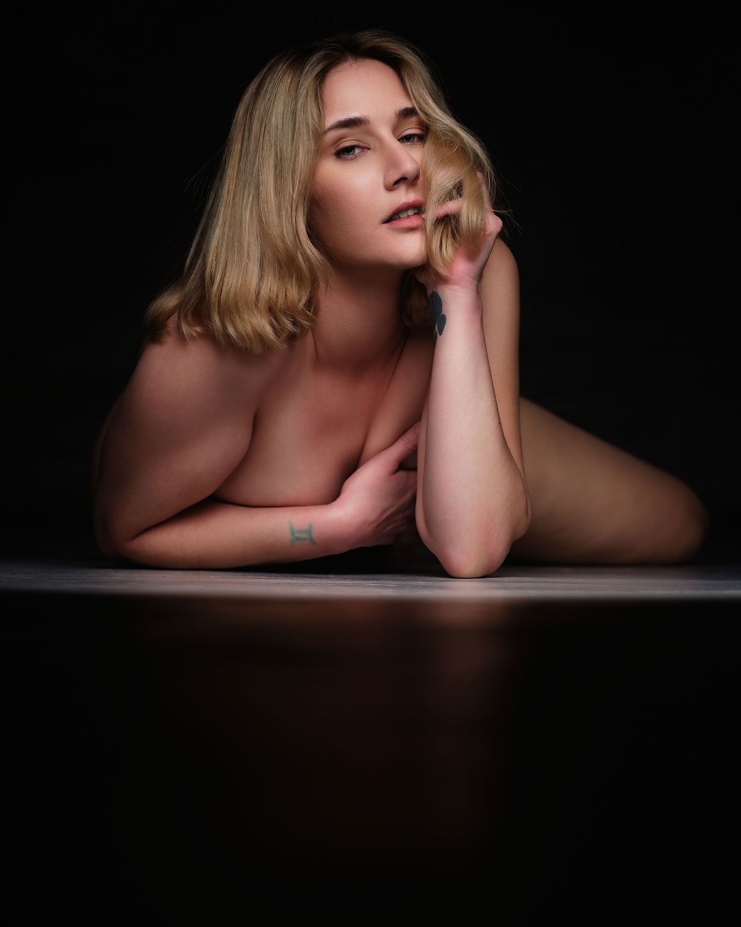 David G Holt Photography - Intimate portrait with soft lighting showcasing natural beauty against dark backdrop.