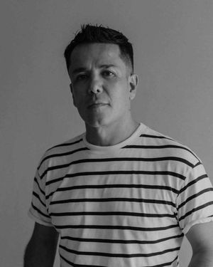 Person wearing a striped black and white t-shirt shown from different angles in monochrome lighting.