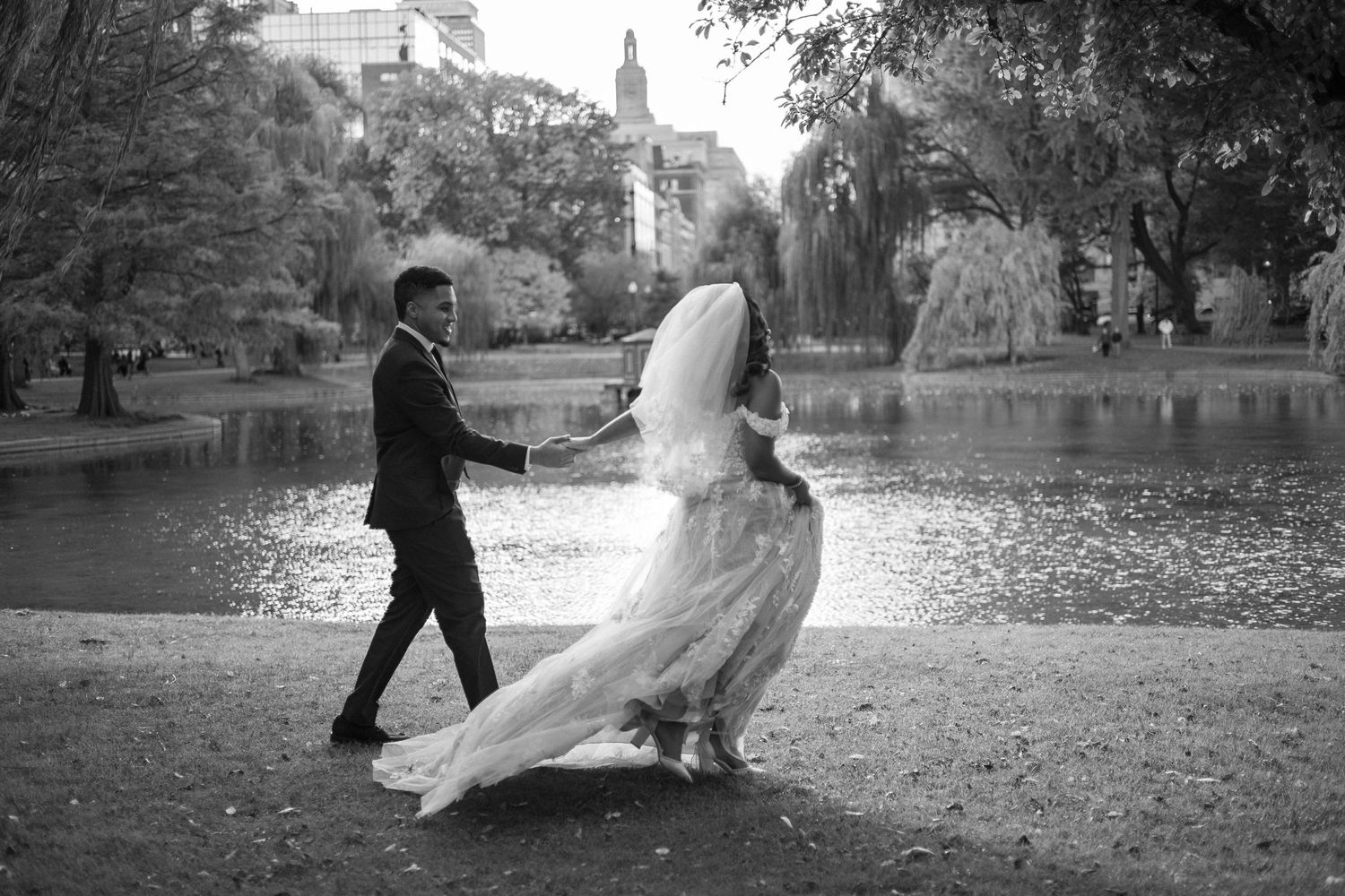 A romantic black and white wedding photo captured in Central Park with the bride's dress flowing in the wind.