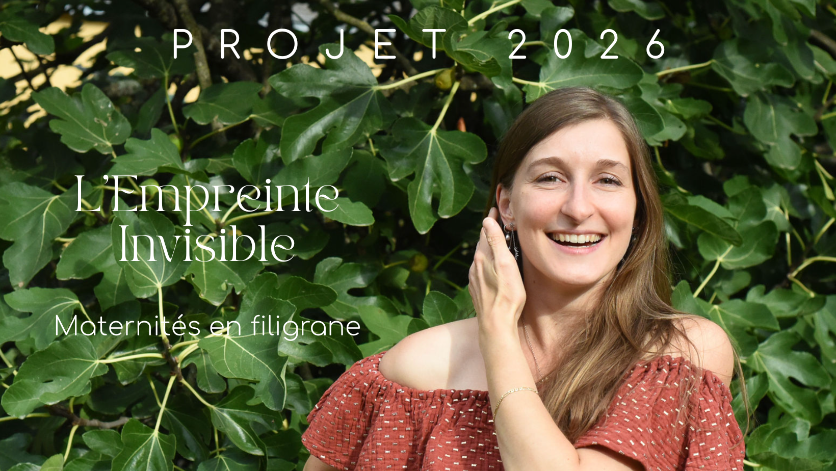 A person laughs joyfully while sitting outdoors surrounded by lush green foliage in natural lighting.