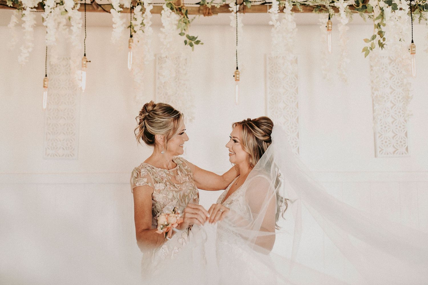 Bride sharing a quiet, emotional moment with her mother before the ceremony at her spring wedding at Towering Oaks Wedding Venue.
