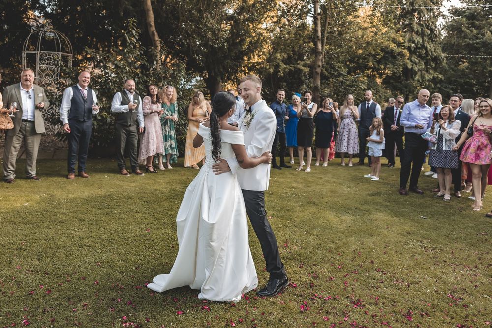 Candid moment of newly weds during their first dance in the summer evening light.