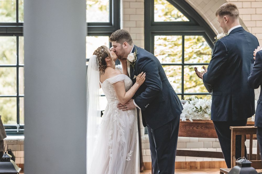 Documentary wedding photography capturing bride and grooms first kiss at a Nottinghamshire wedding venue.