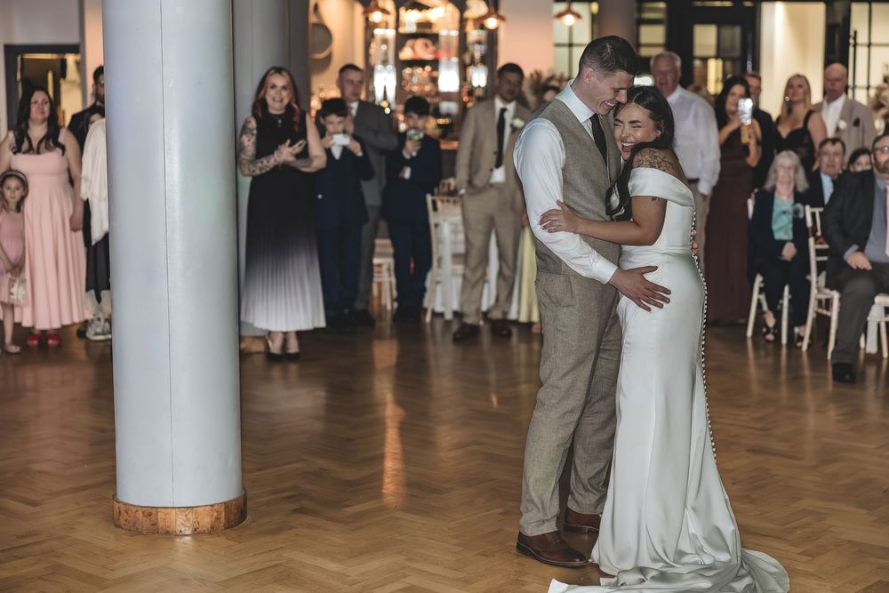 Natural wedding photography moment capturing couple during their first dance at The Pumping House wedding venue.