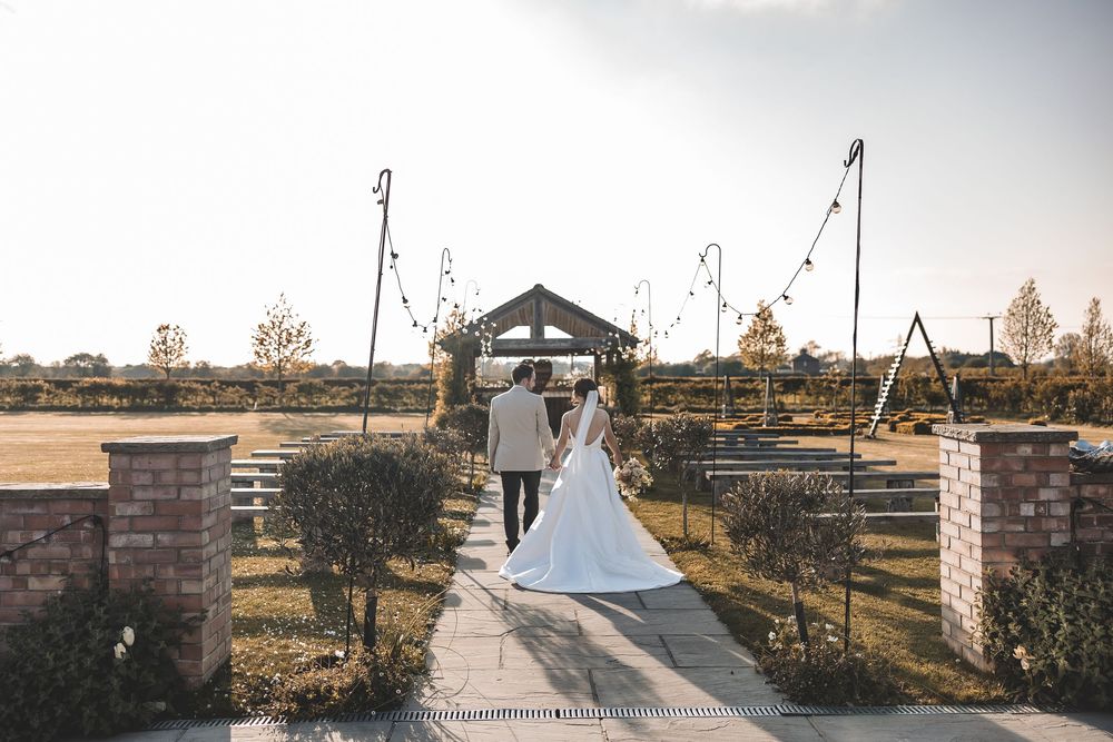 Unposed wedding photo of couple walking into the distance at a Yorkshire wedding venue.