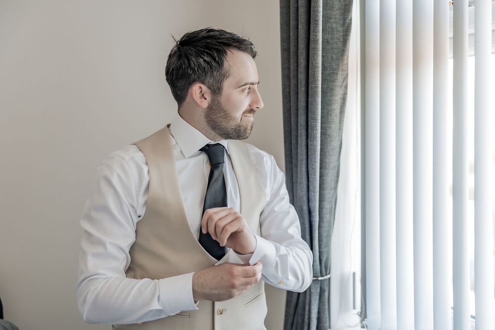 Relaxed portrait of groom getting ready on his wedding day.
