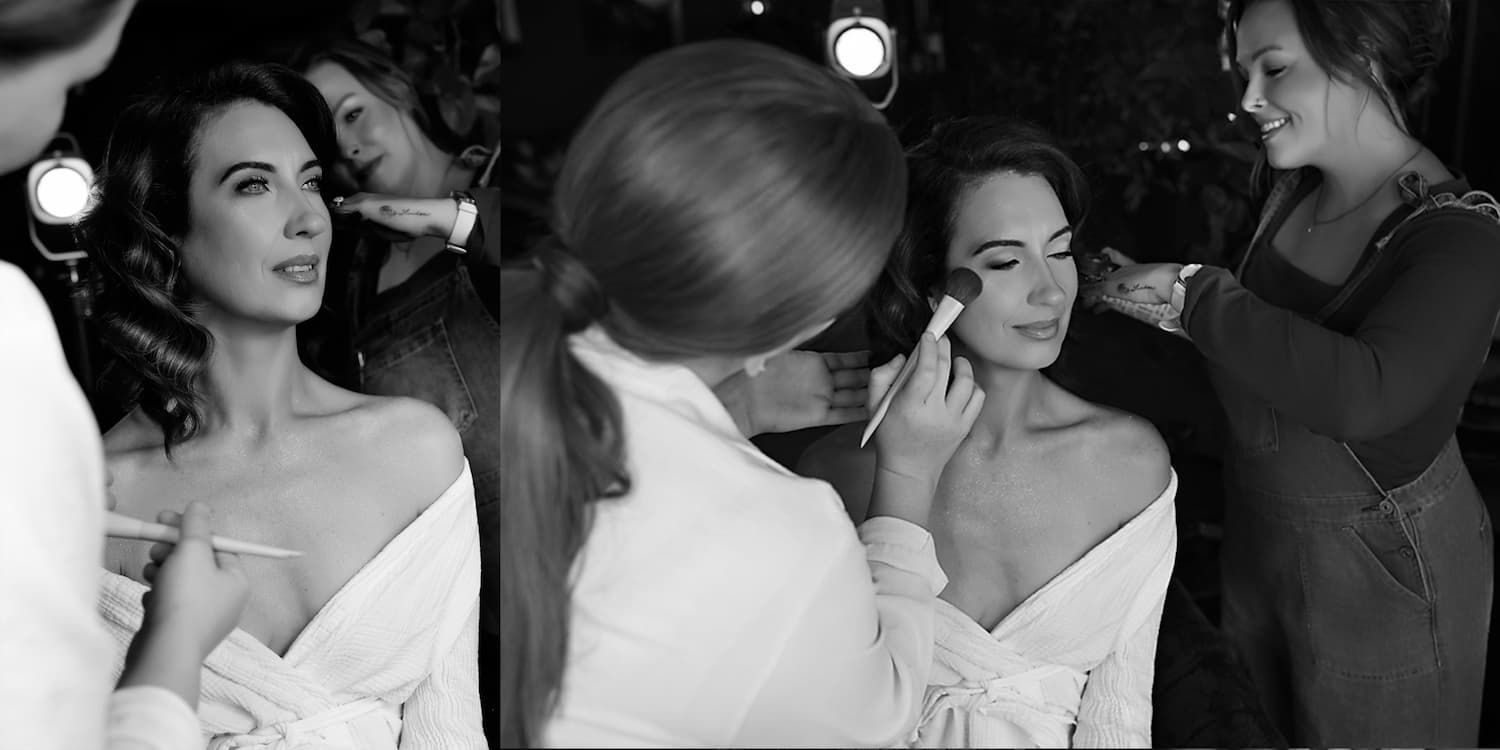 A black and white photograph shows women in elegant evening gowns gathered backstage at a glamorous event.