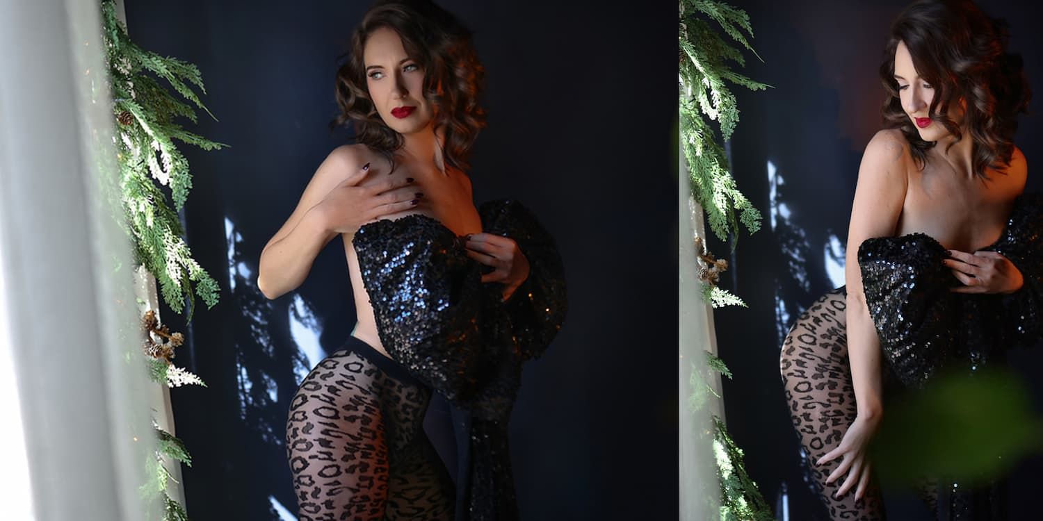 A person in a sparkly evening gown poses gracefully in a moody, atmospheric setting.