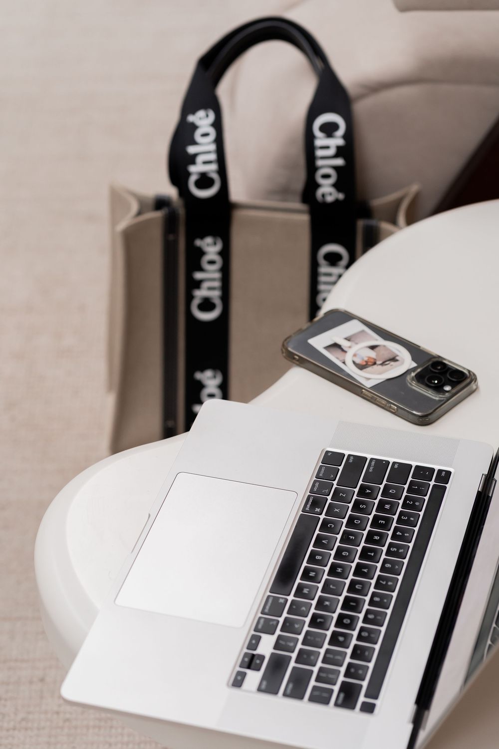 A white laptop keyboard with black keys shown from multiple angles on a light colored surface.