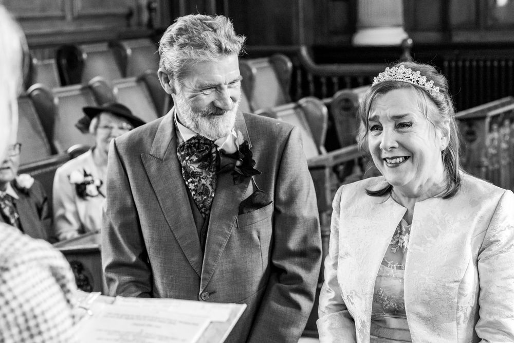 Dorothy and John smile during their Southport Town Hall wedding ceremony, captured in a natural documentary style moment.