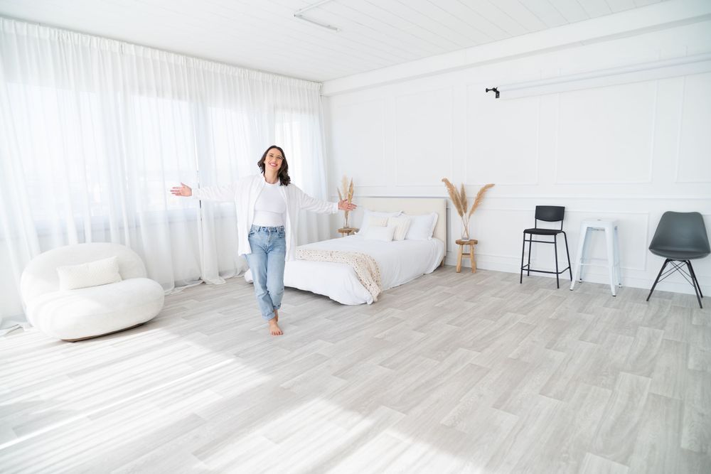 A bright white studio space with light wood flooring and multiple images showing different angles of the empty room.
