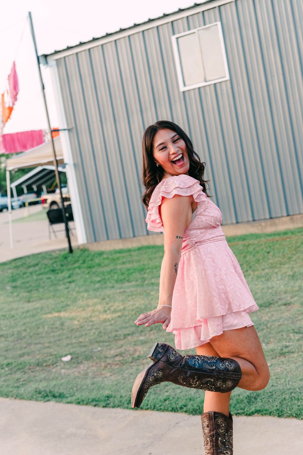 A playful outdoor portrait against a metal building.
