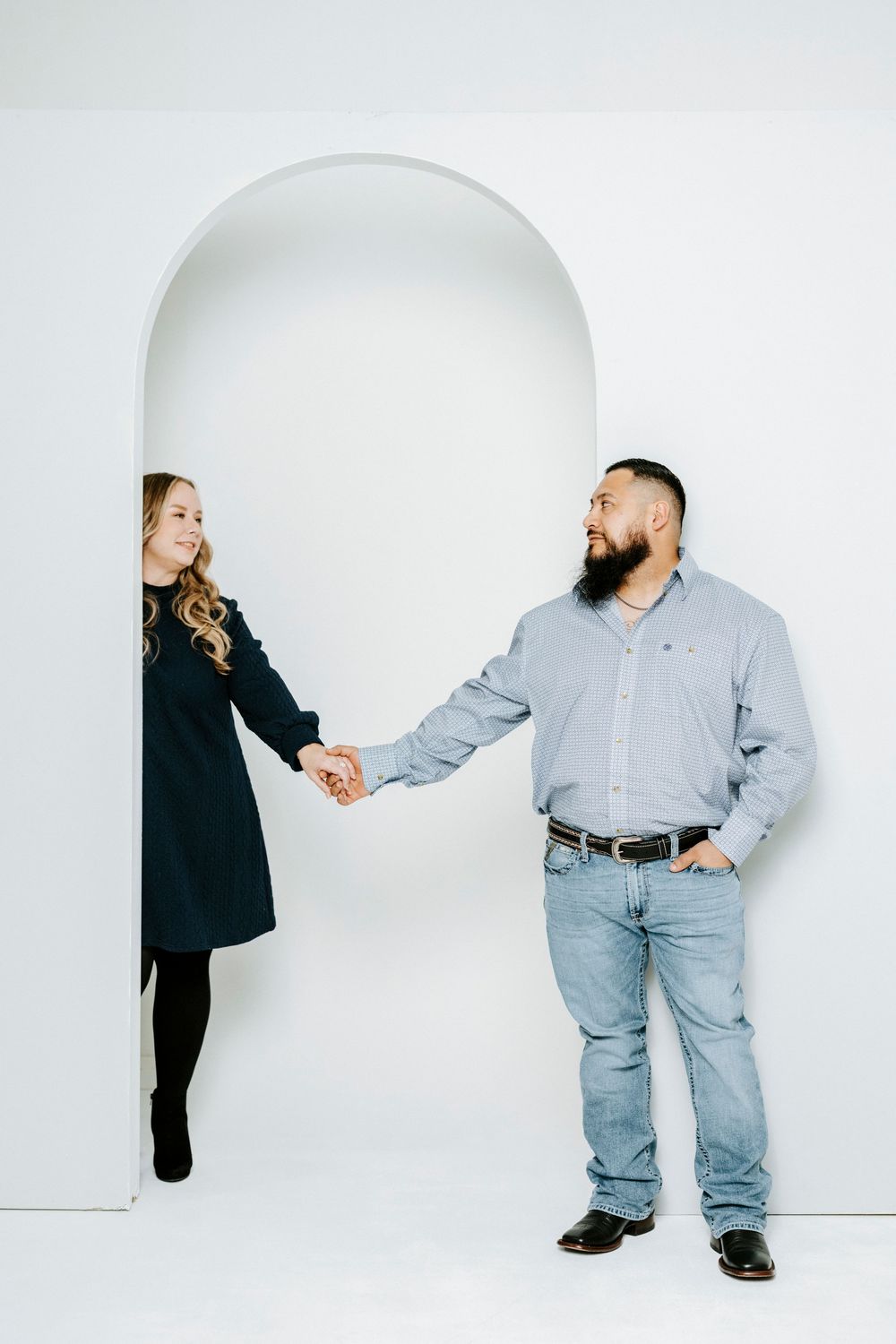 Two people interact in a minimalist white studio setting showing a sequence of playful movements.