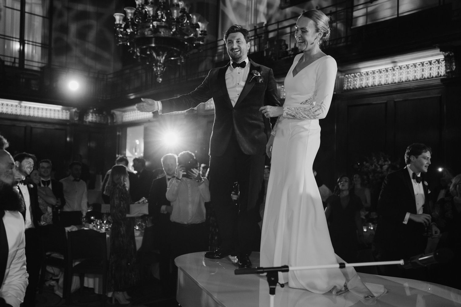 bride and groom dancing on top of piano while London function band performs at Merchant Taylor's Hall in London
