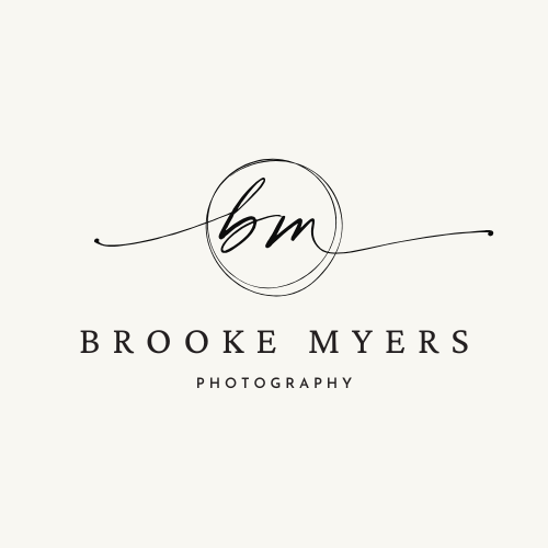 Black and white photography logo with cursive monogram in circular design.