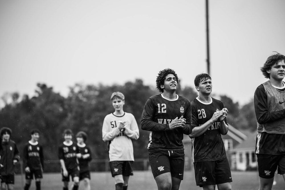 Soccer players jog together during team practice session.