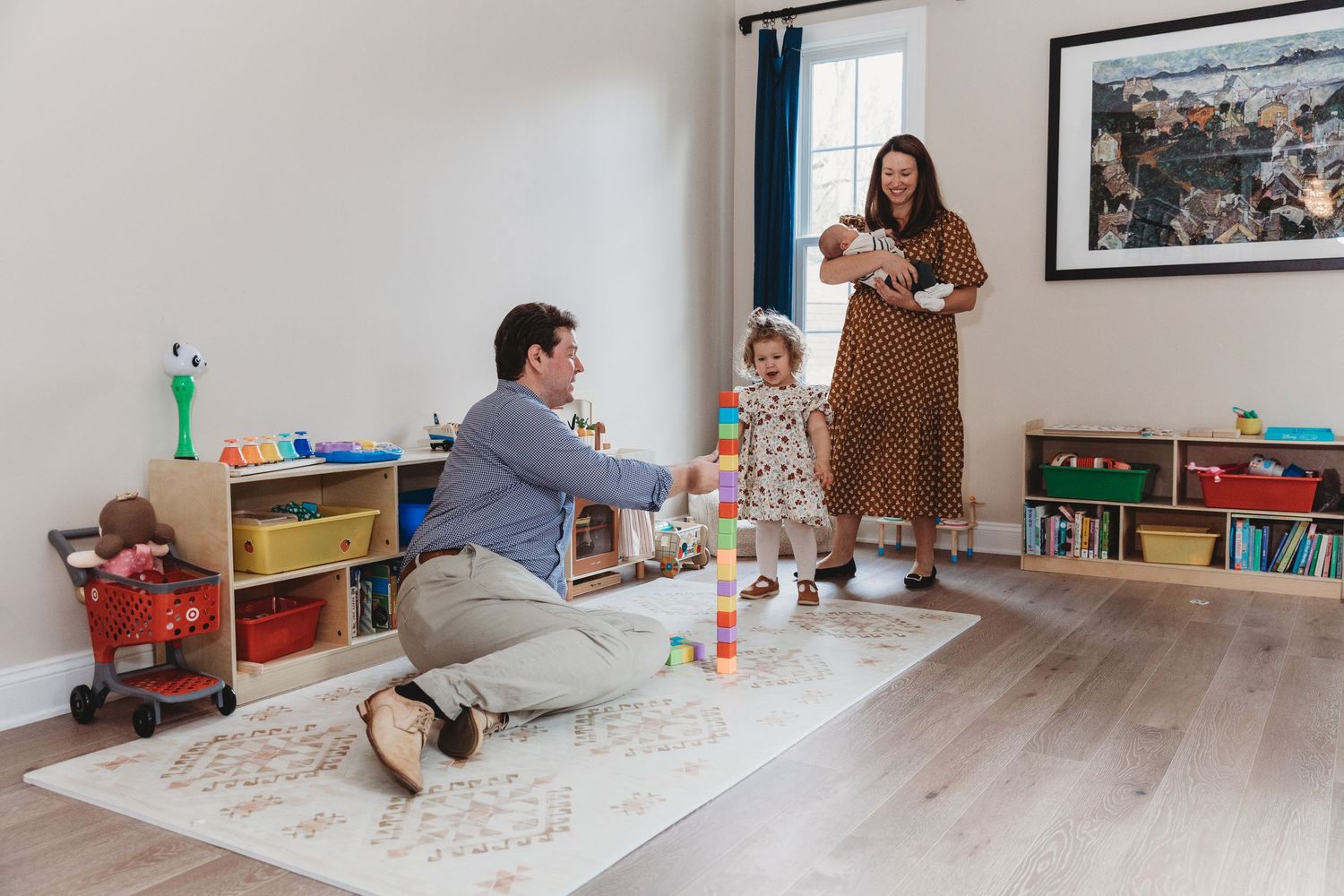 In-home lifestyle photography session showing casual family moments in bright living space.