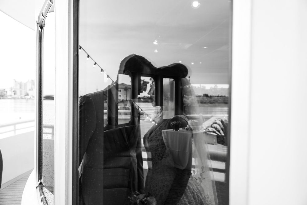 Black and white photograph showing interior hallway with doorways and window light creating geometric shadows. Micro wedding on Yacht StarSh