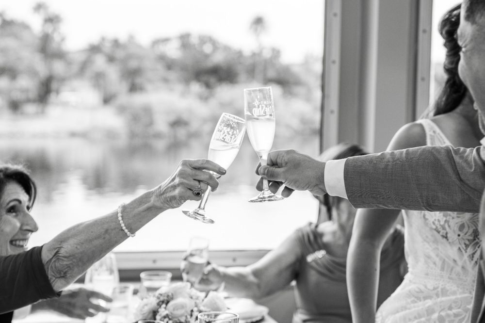 A group of people enjoying drinks and socializing at a lively outdoor gathering. Micro wedding on Yacht StarShip in Tampa