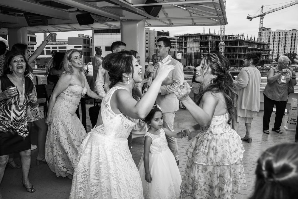 A group of people in elegant white wedding dresses browse through a bridal boutique showroom. Micro wedding on Yacht StarShip in Tampa