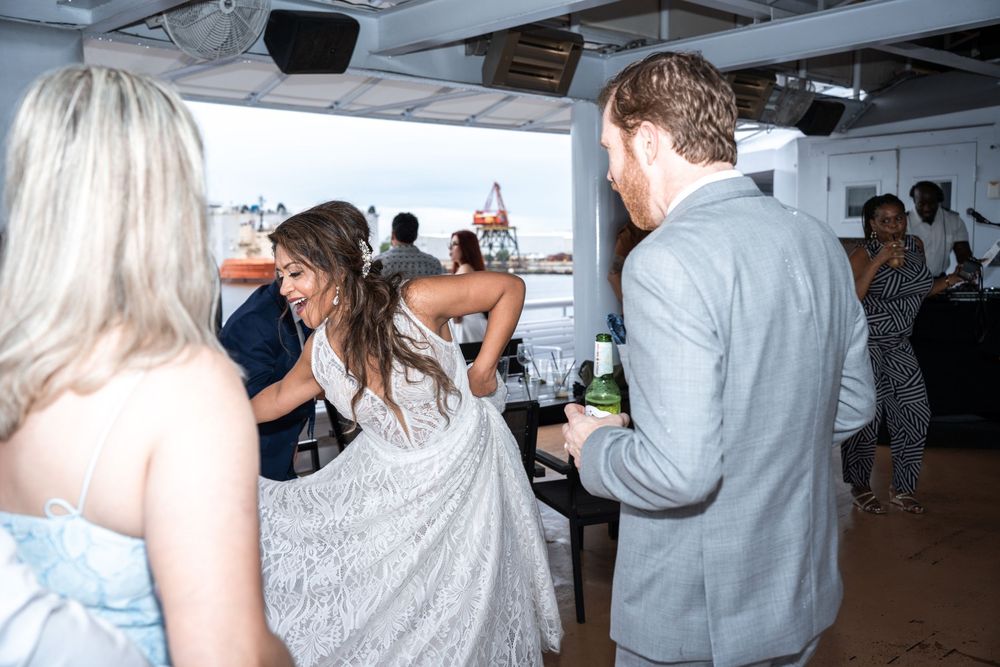 Guests dancing and celebrating during a lively boat party reception. Micro wedding on Yacht StarShip in Tampa