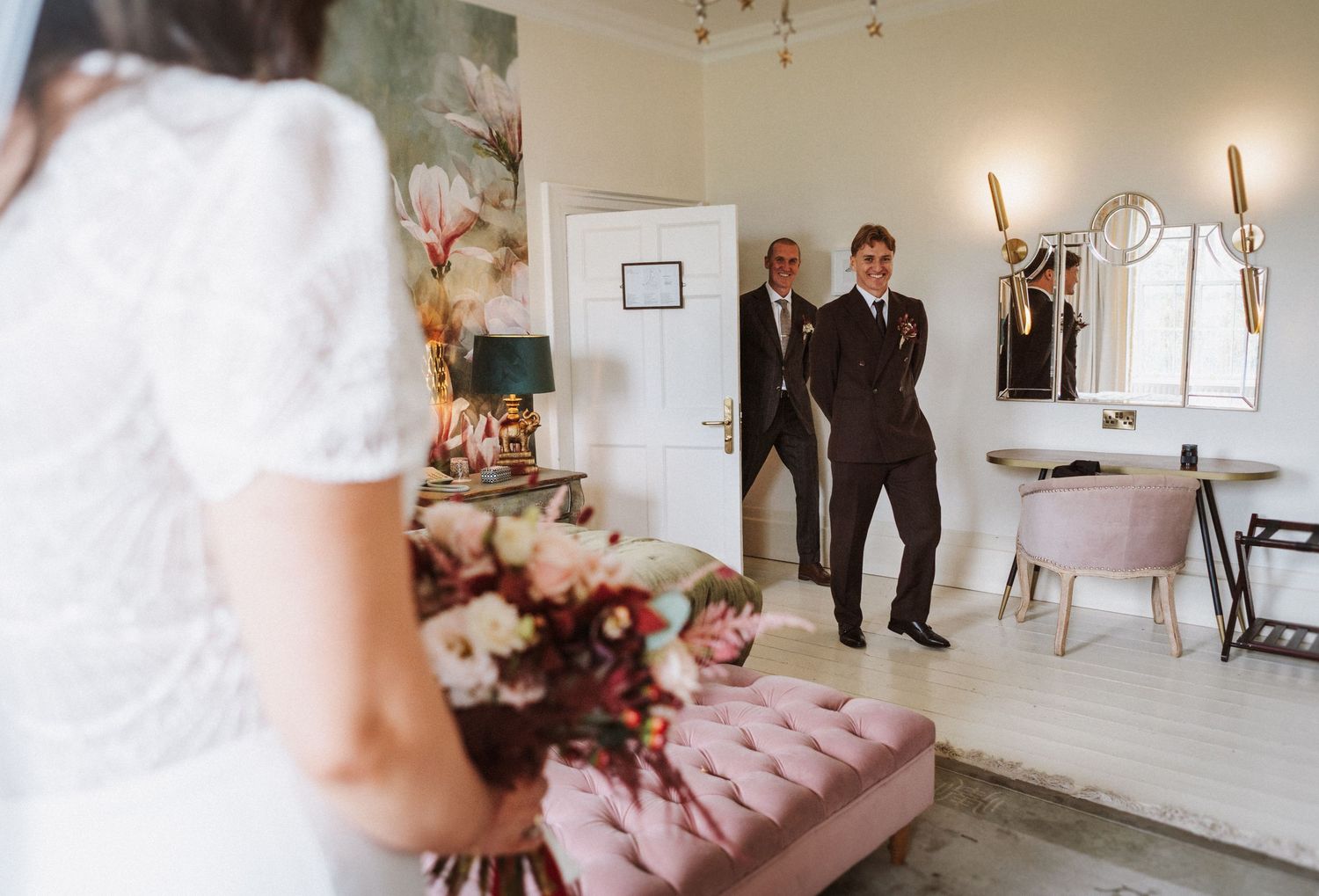 Elegant wedding venue interior with soft lighting, floral arrangements and classic decor.